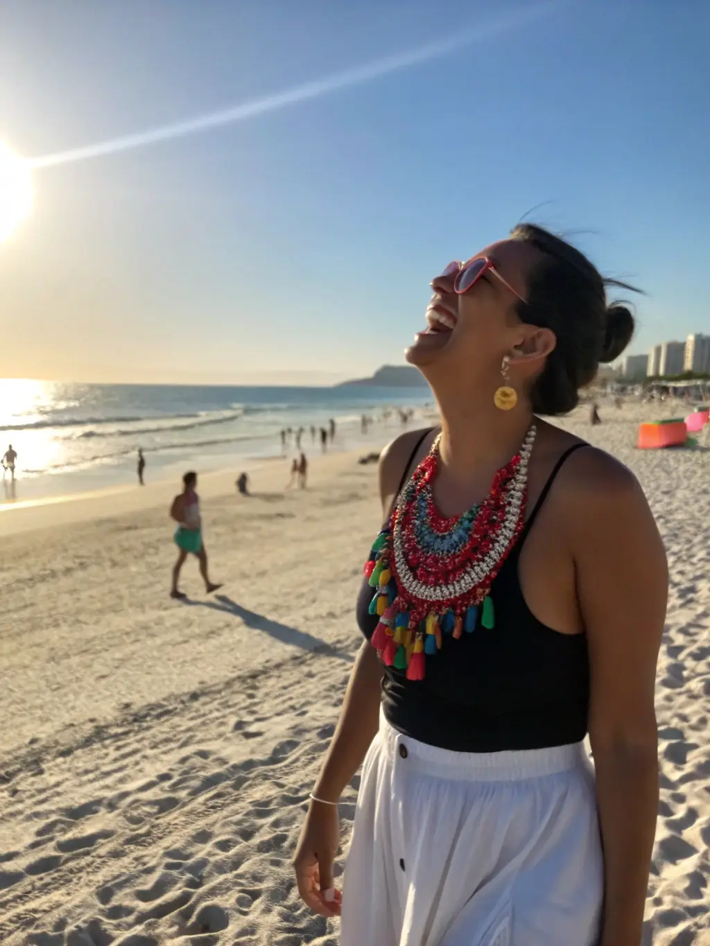 A woman wearing a Summer Dress A, walking on a sunny beach, holding Stylish Sunglasses C, showcasing the perfect summer outfit.